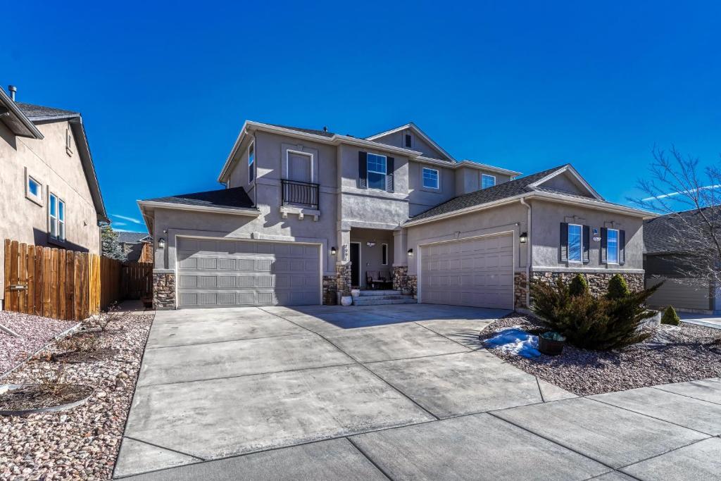 a house with a driveway and a garage at Selah Springs Lodge in Colorado Springs