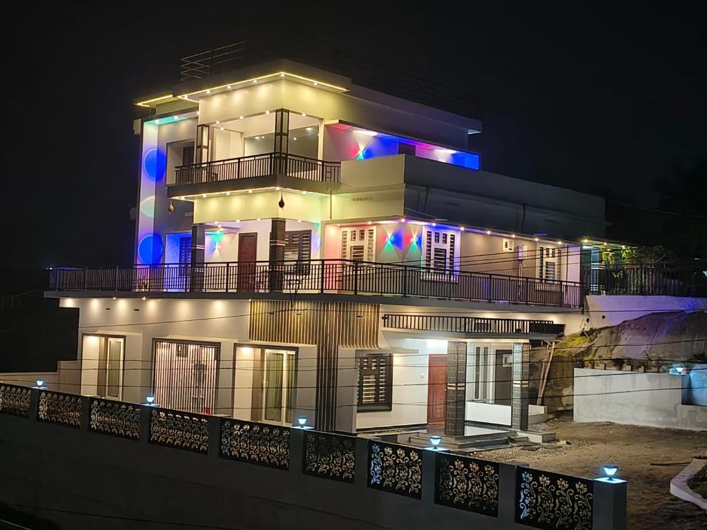 a large building with lights on it at night at Bro Code Marayoor A Premium Family Friendly Retreat with Panoramic Mountain Views in Maraiyūr