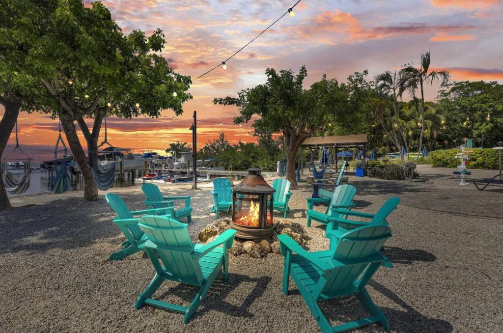 a group of chairs sitting around a fire pit at Paradise at Moon Bay in Key Largo