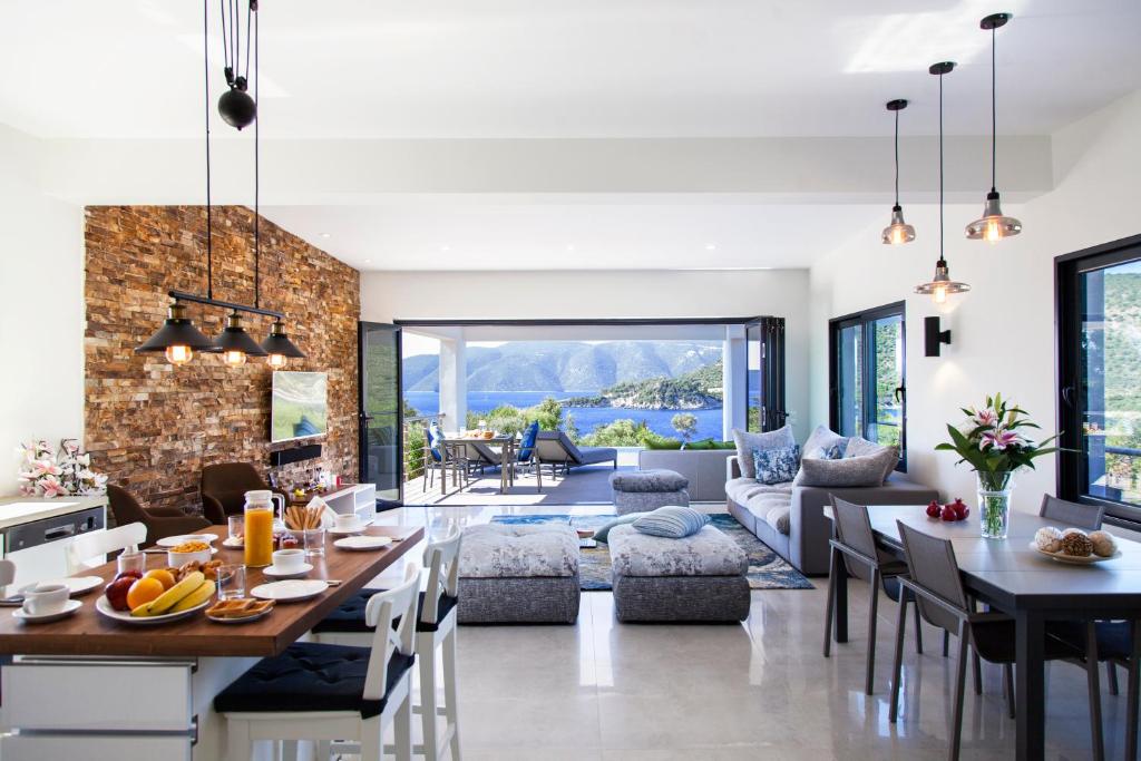 a kitchen and living room with a table and chairs at Villa Del Mar in Vasiliki