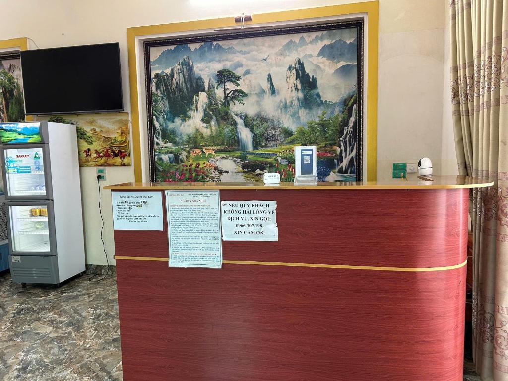 a large painting on a wall above a wooden door at Anh Đàm Motel in Vĩnh Phúc