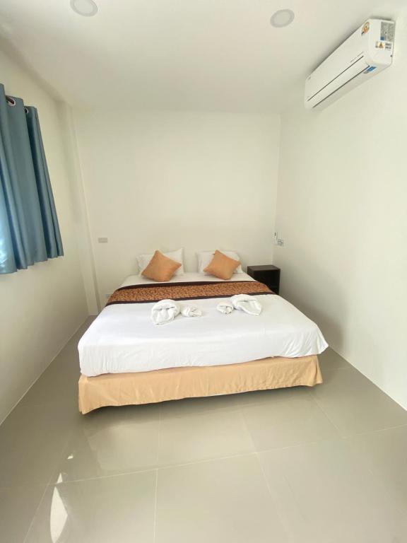 a bedroom with a bed in a white room at Lantara resort in Ko Lanta