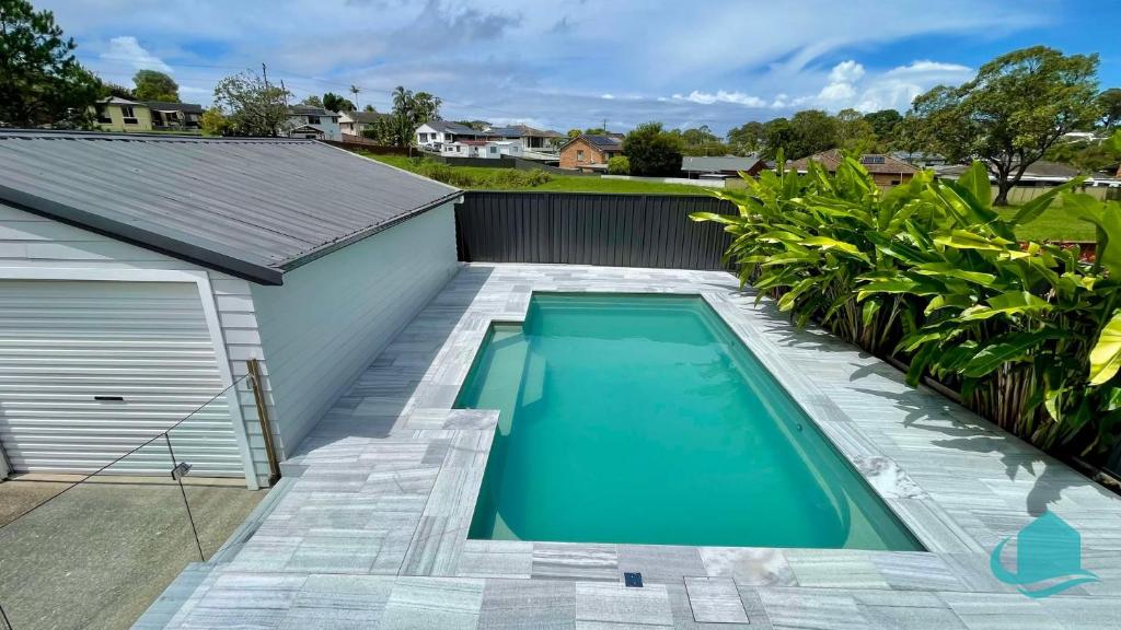 a swimming pool in the backyard of a house at Casa Calvi - Central location with Pool in Jewells Station