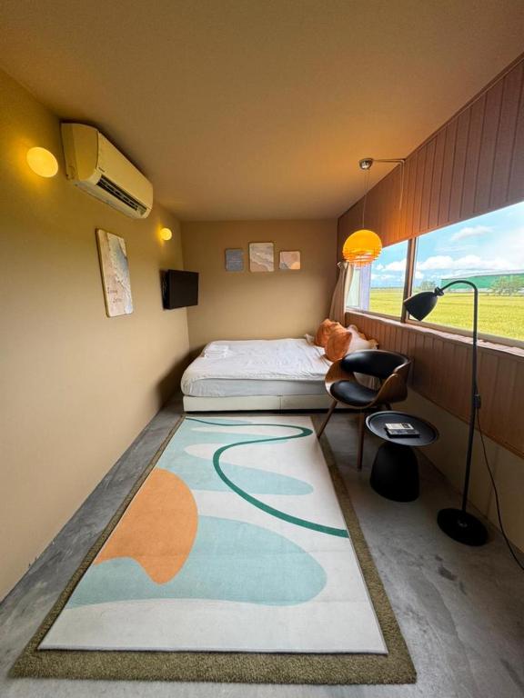 a bedroom with a bed and a large rug at Padi Box Homestay in Sekinchan