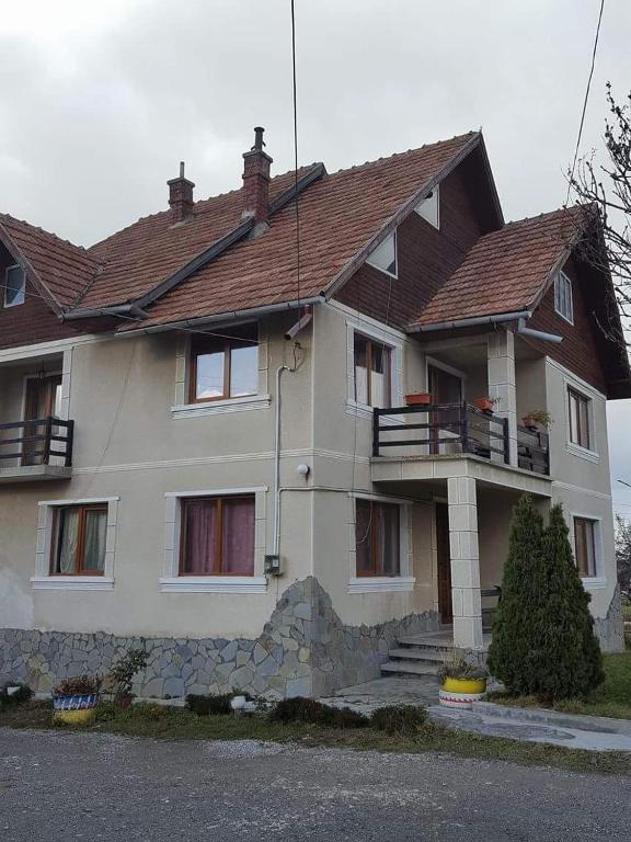 a large white house with a brown roof at Pensiunea Cristomar in Bran