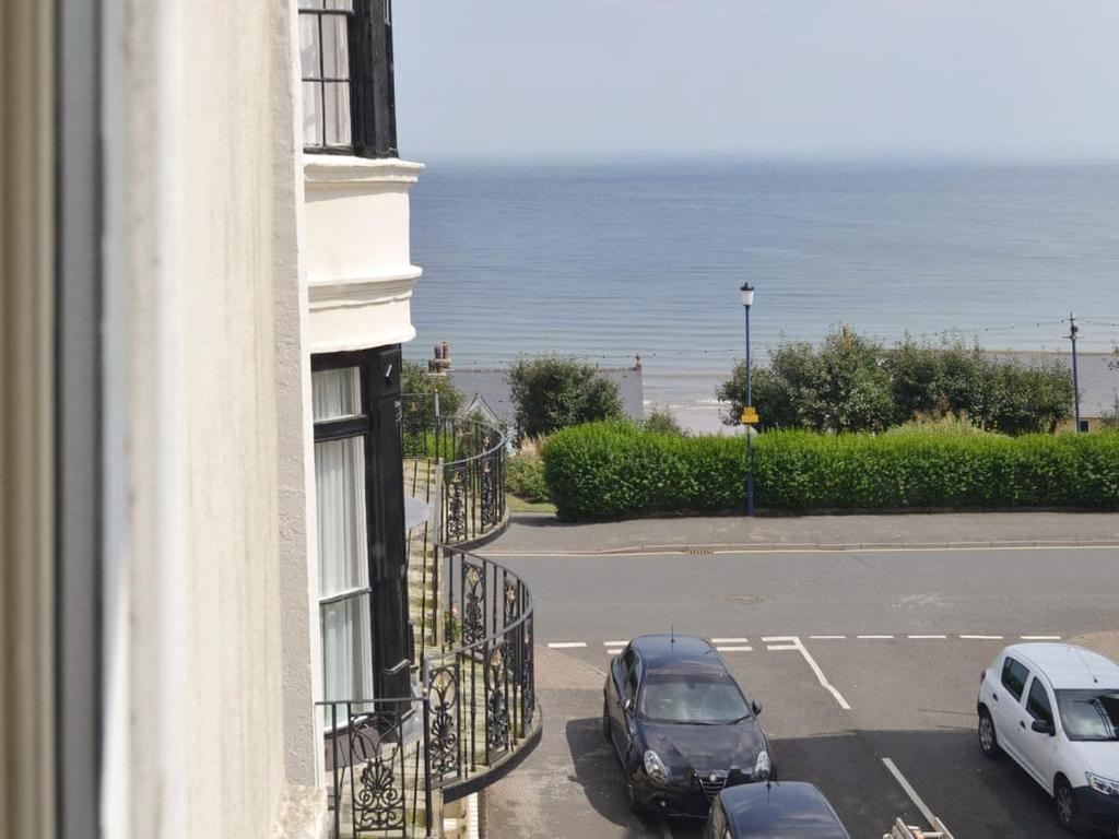 a view of a building with cars parked in a parking lot at Anchor's Away in Filey