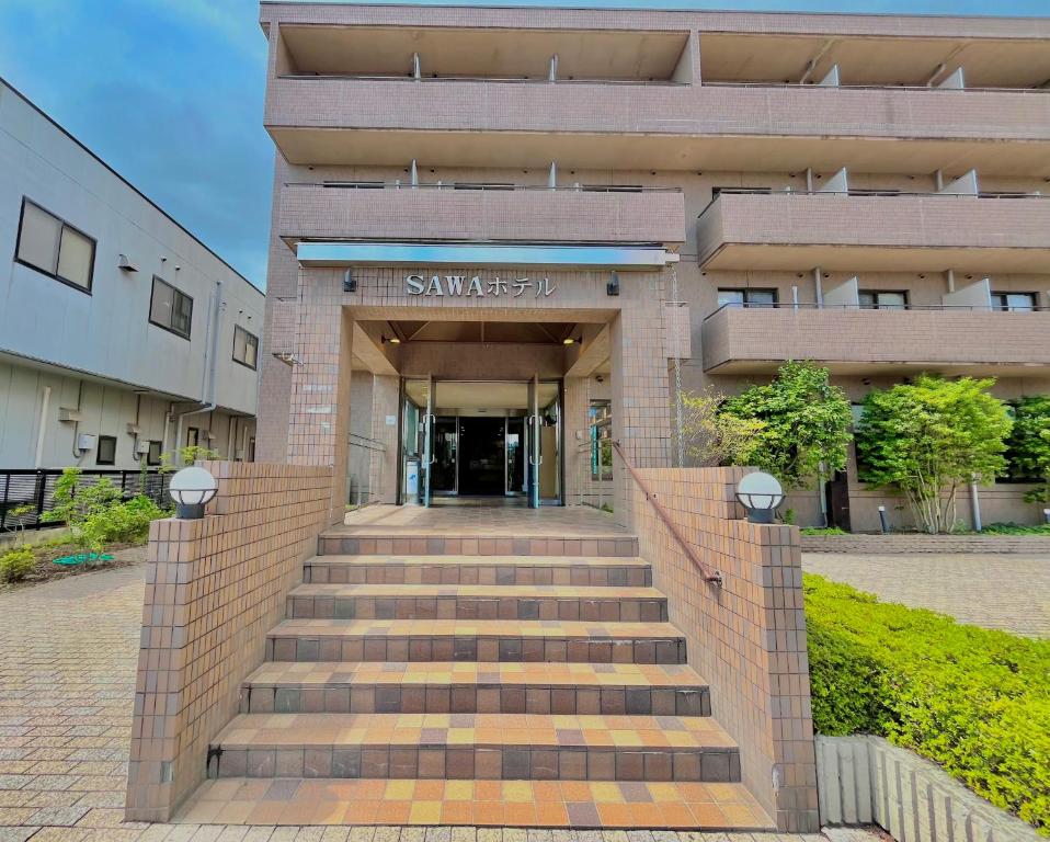 a building with stairs in front of a building at Sawa Hotel in Fujikawaguchiko