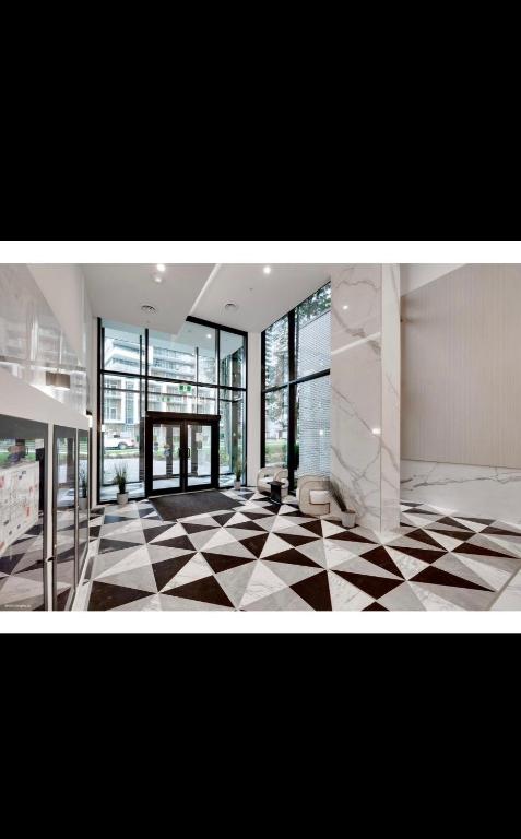 a large room with a checkered floor and large windows at Cozy 1 bed and 1bath suit in Surrey