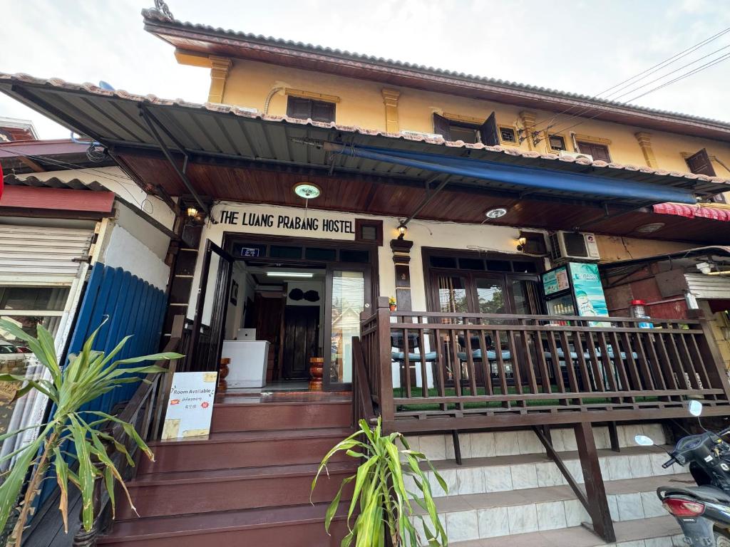 a building with a sign on the front of it at Isano Guesthouse in Luang Prabang