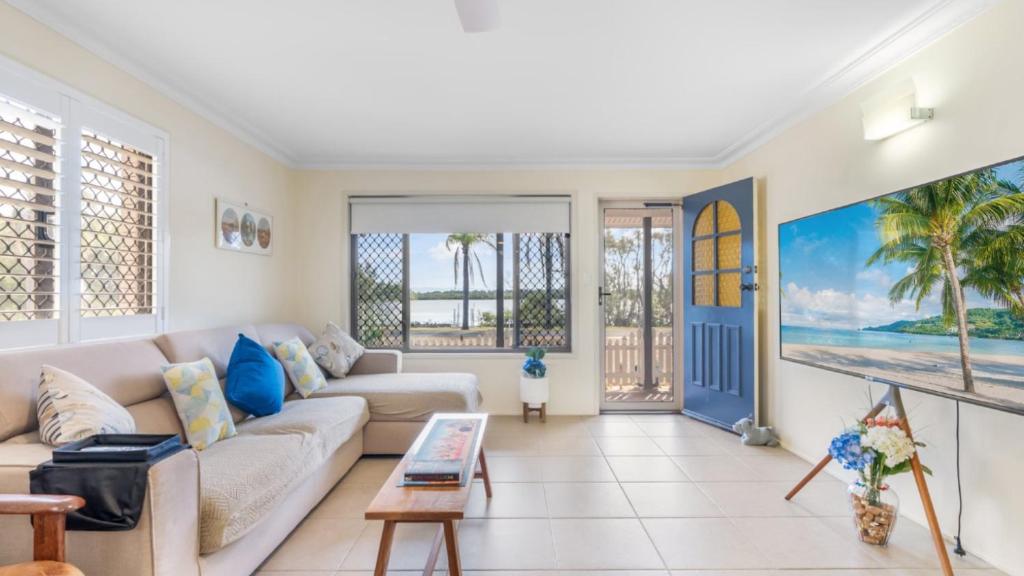 a living room with a couch and a table at Driftwood At Beachmere in Beachmere