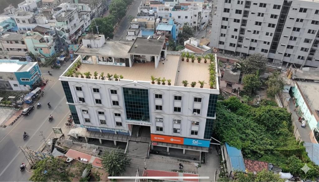 an overhead view of a white building in a city at Anand Comfort in Anakāpalle