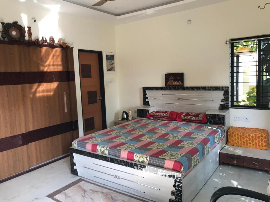 a bedroom with a bed in a room at Vishnoo Stays Lush Green Room in Atal Nagar in Nawāgaon