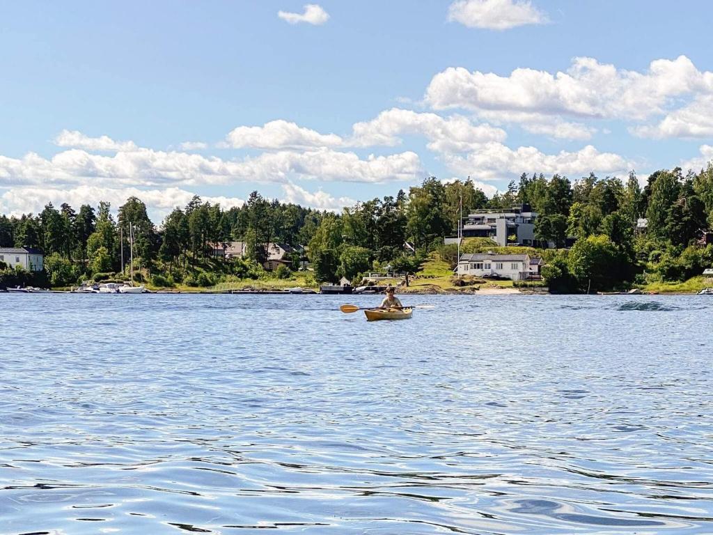 a person in a boat on a lake at 9 person holiday home in NESØYA-By Traum in Sandvika