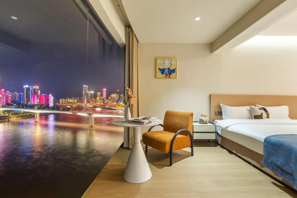 a hotel room with a bed and a view of a city at Skyline Riverview Apartments in Chongqing