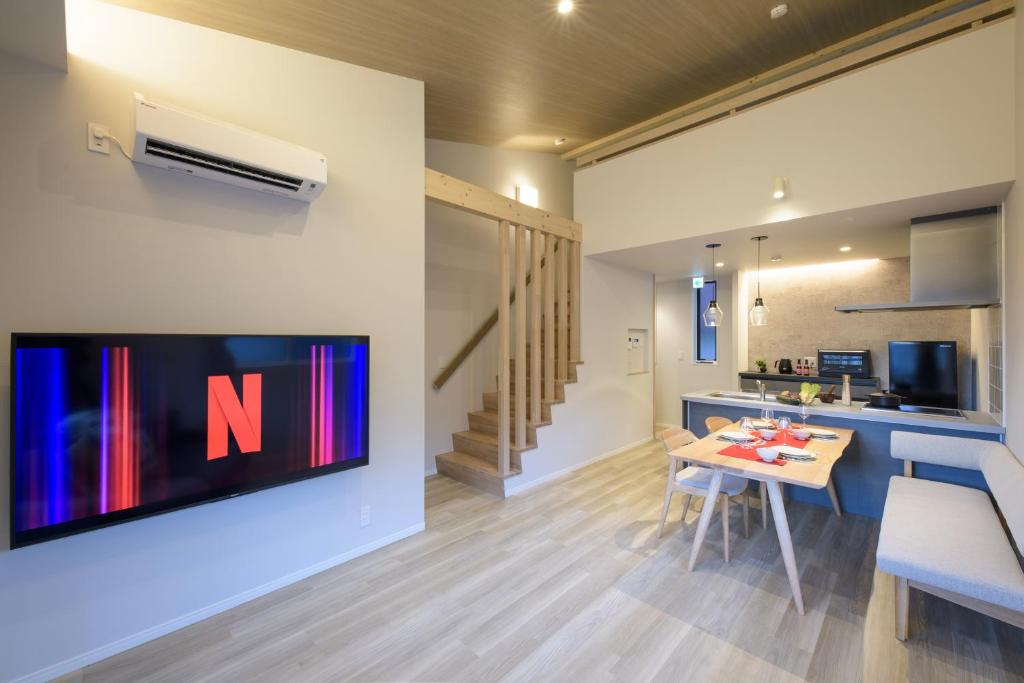 a living room with a tv on a wall at TEMARI Premier NORTH in Hakone