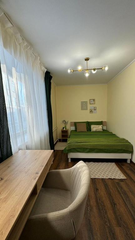 a bedroom with two beds and a couch in it at Апартаменти GREEN центр вулиця Руська in Ternopil