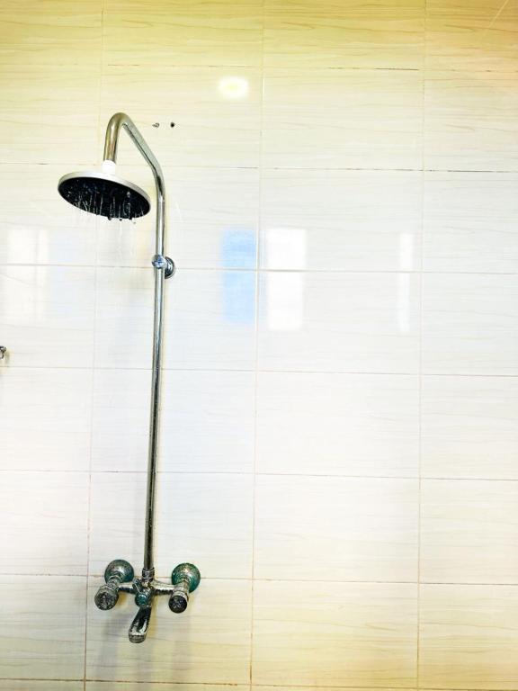 a shower in a wall with a shower head at The Hidden Gem Near Central B&B in Nkunjila