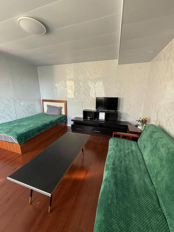 a living room with two beds and a couch at Mini apartment in Central UB in Ulaanbaatar