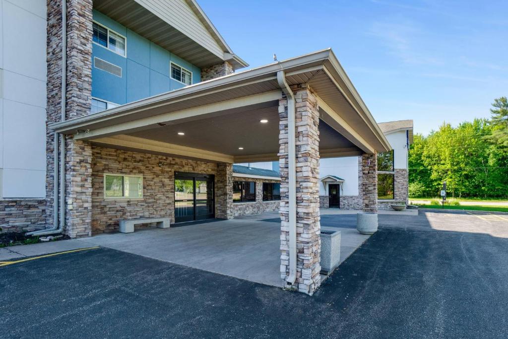 a building with an open garage in front of it at Comfort Inn & Suites Weston - Wausau in Weston