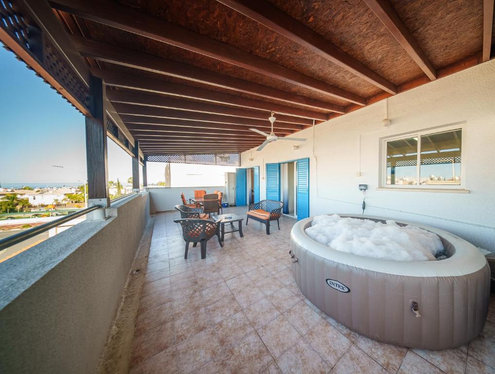a hot tub on the balcony of a house at The Blue Mile w Jacuzzi in Paralimni