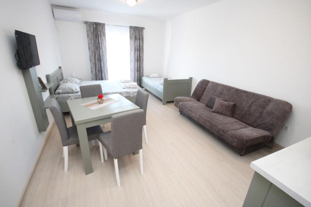 a small living room with a couch and a table at Apartments KA-7 in Podgorica
