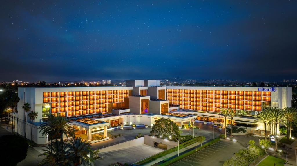 a large building with lights on in a city at night at Hilton Orange County/Costa Mesa in Costa Mesa