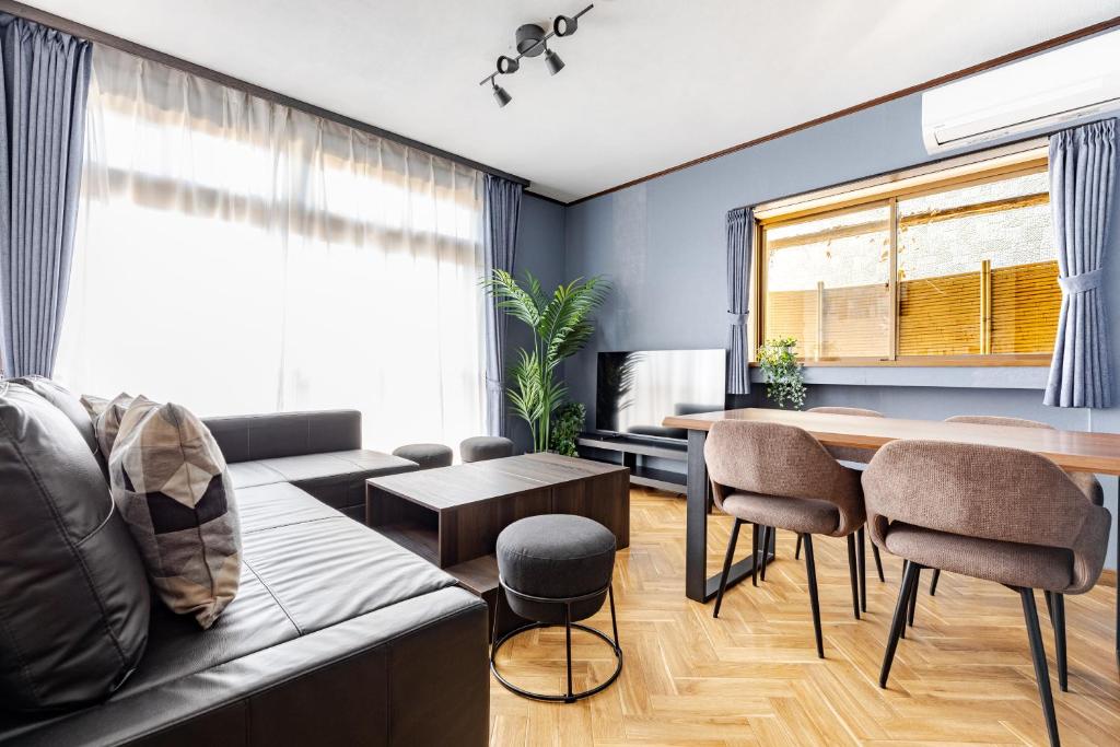 a living room with a couch and a table at Comfort Villa Takahata in Takahate