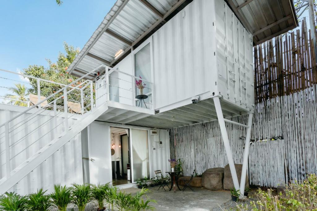 a house with a staircase on the side of it at serene hotel in Chiang Mai