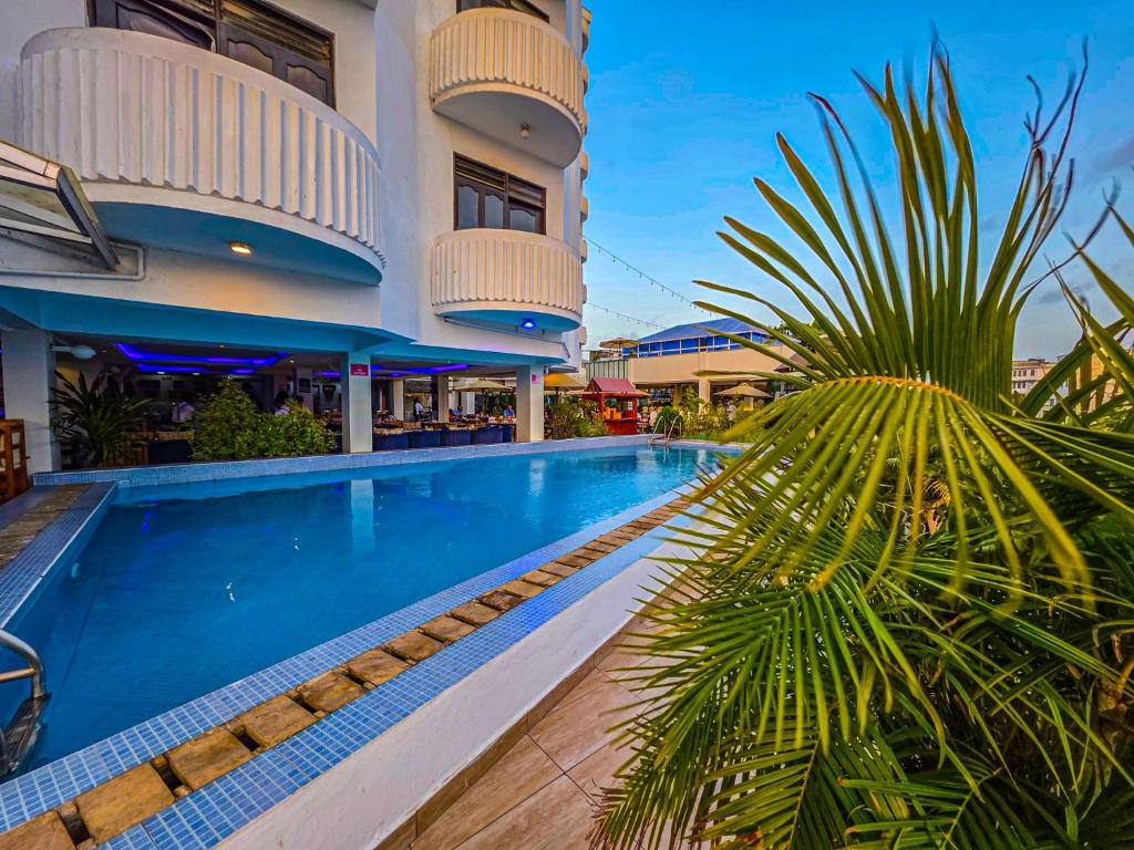 a villa with a swimming pool in a resort at Hotel Sapphire in Mombasa