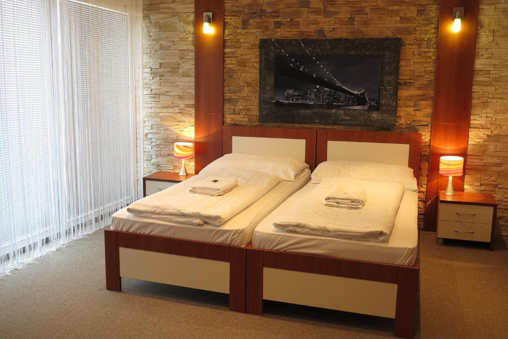 a bedroom with a bed with two towels on it at Hotel 21 in Bratislava