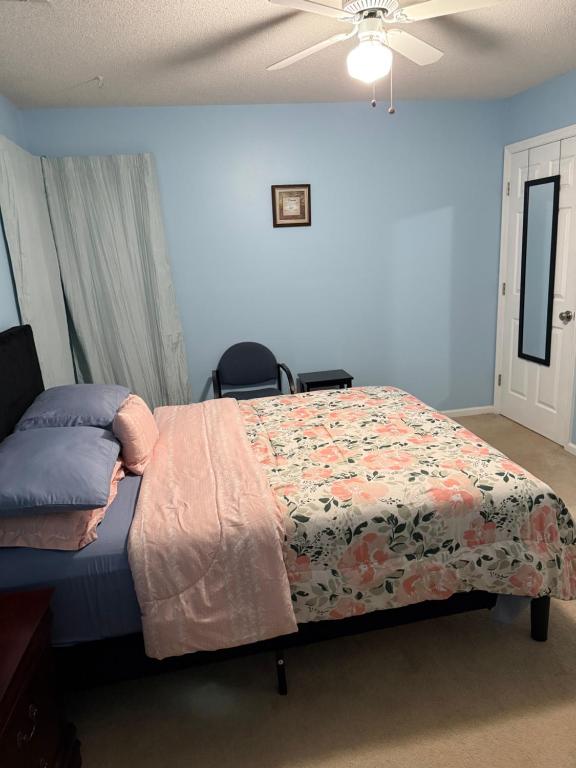 a bedroom with a bed and a ceiling fan at Serenity in Statesboro