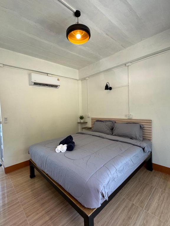 a bedroom with a bed with a stuffed animal on it at The cozy house in Trang