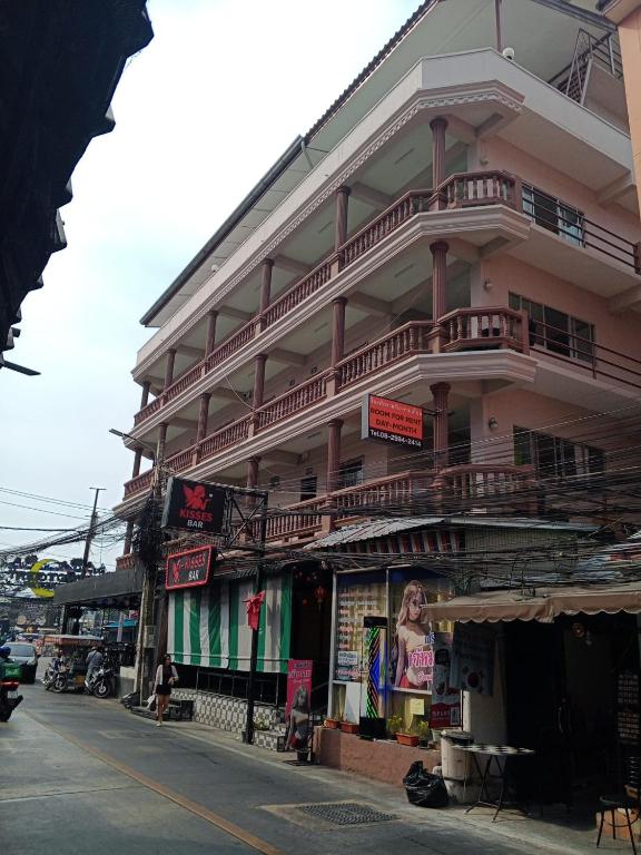 a tall building with balconies on the side of a street at Nana's Apartment in Pattaya