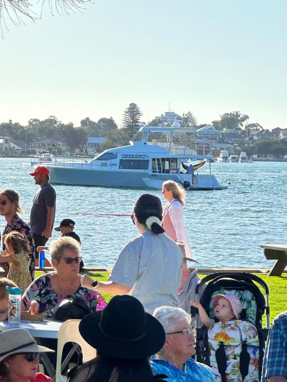 a group of people sitting on a boat in the water at Manduhra Motel Resort in Mandurah