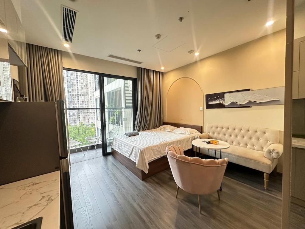a hotel room with a bed and a couch at R1 Studio Ruby Zenpark in Gia Lâm Pho