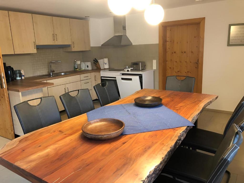 a kitchen with a wooden table with two bowls on it at Ferienhaus Kollmer in Bad Koetzting