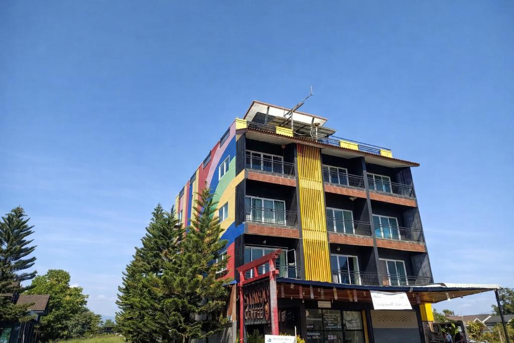 a tall building with a colorful facade at B&T Hostel in Ban Pa Tung (7)