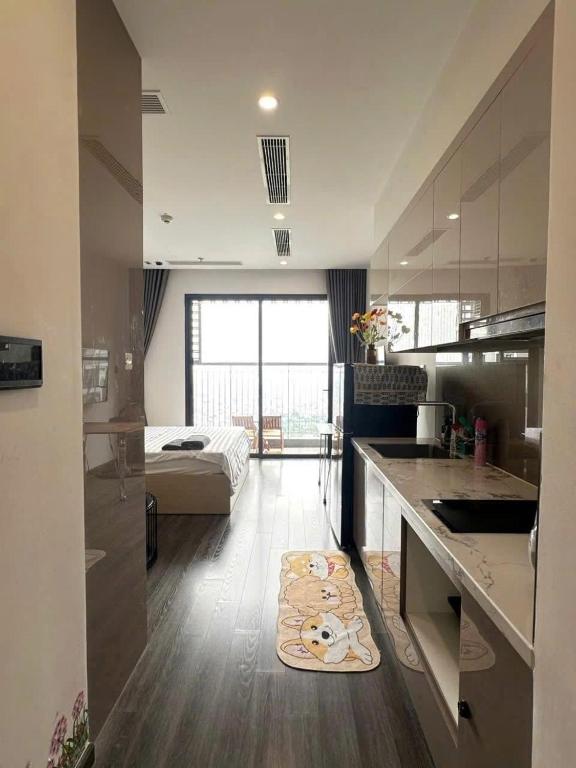 a kitchen with a counter and a bed in a room at R1 Studio Ruby Zenpark in Gia Lâm Pho