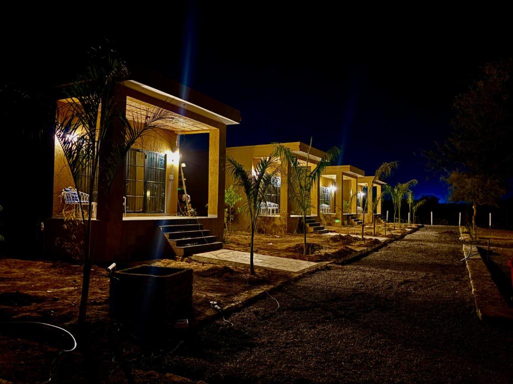 a row of houses at night with lights at Jalsa Jawai Resort in Bīsalpur