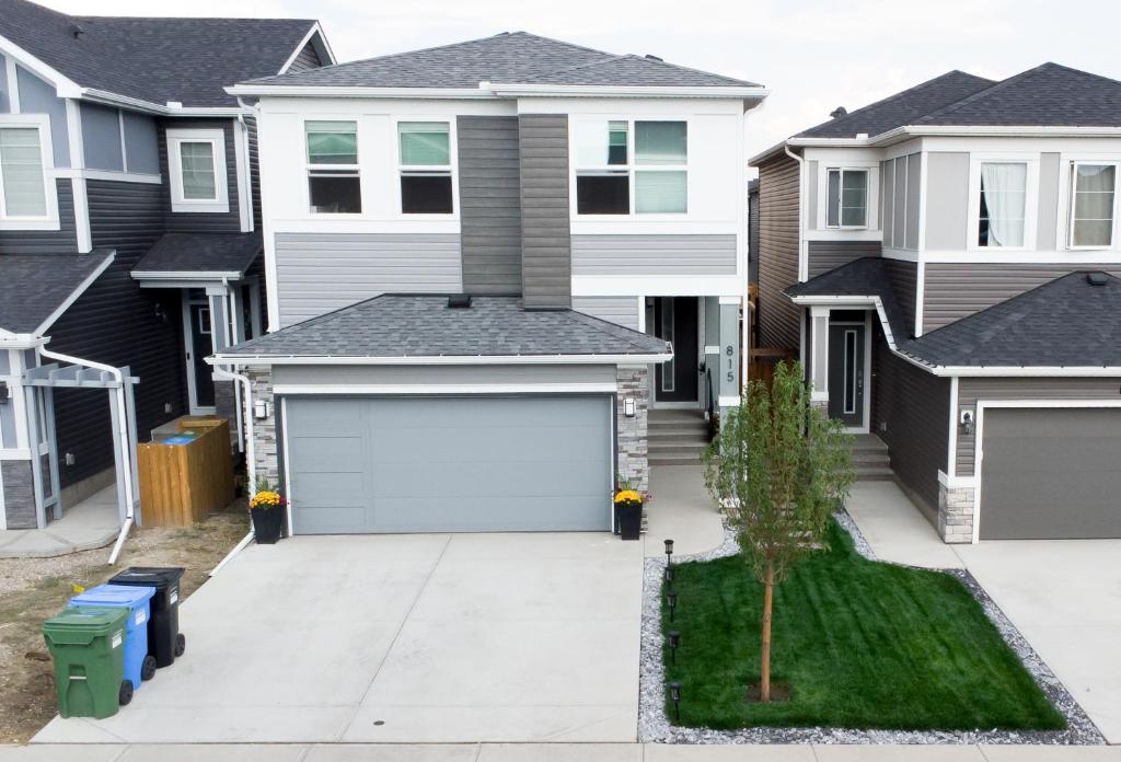a house with a garage in front of it at Cozy Luxe Suites in Calgary