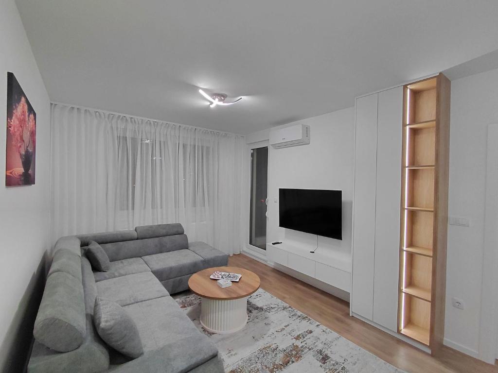 a living room with a couch and a tv at High Above 6 in Vranješ
