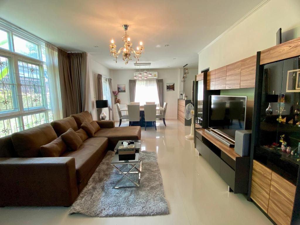 a large living room with a couch and a television at J&Y Happy Home in Ban Rong