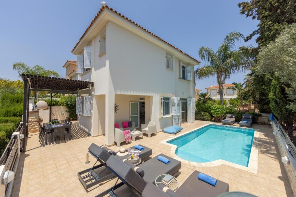 a villa with a swimming pool and a house at Villa Mesogeios 39 in Paralimni