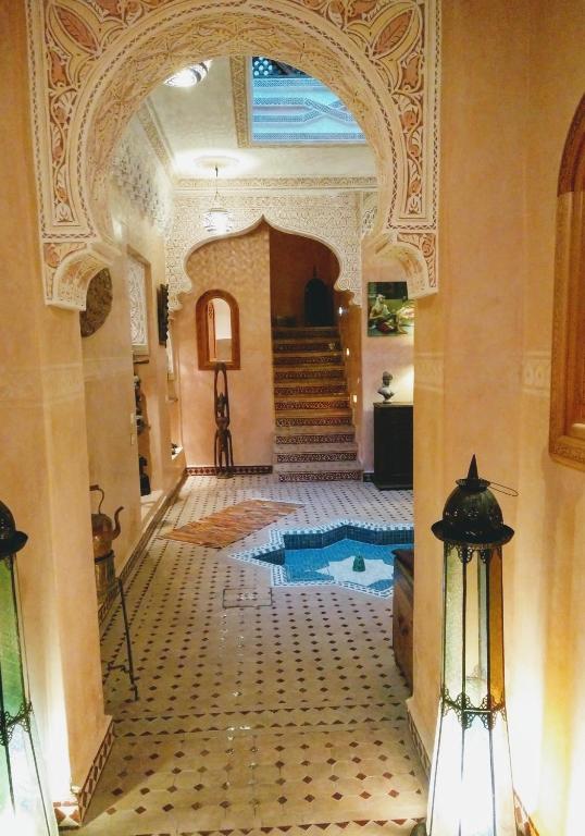 an entry to a building with a pool in the middle at Riad Fadela in El Jadida