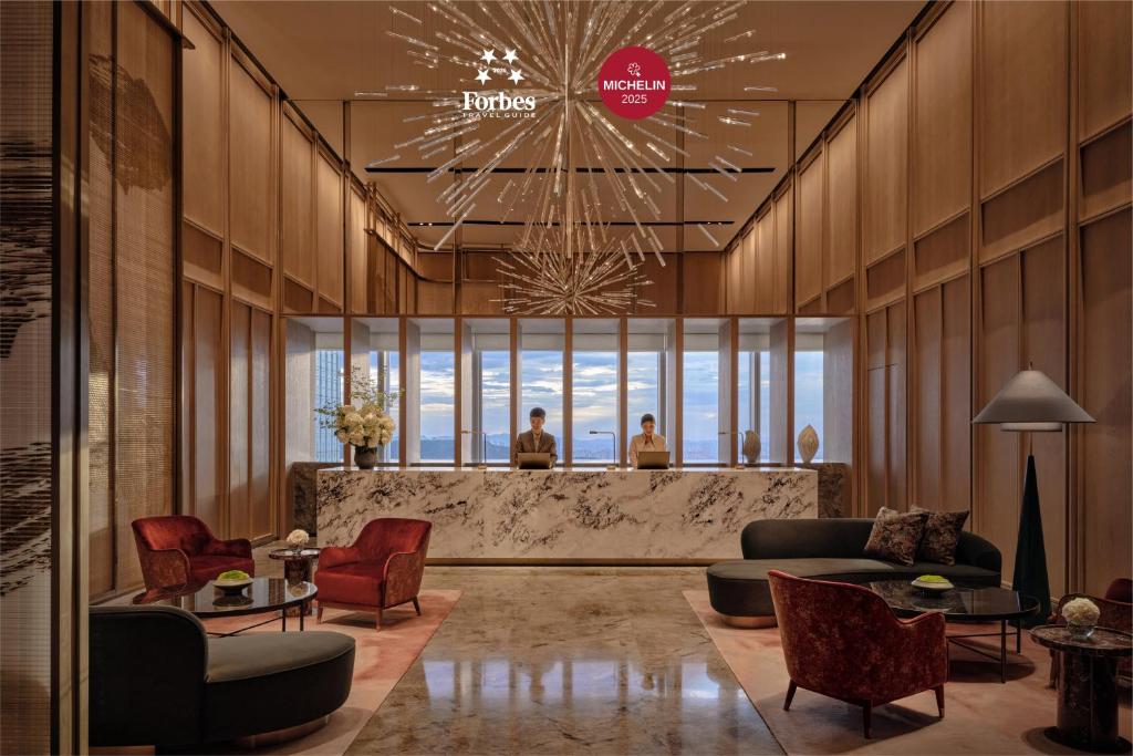 a lobby with couches and chairs and a bar at Park Hyatt Changsha in Changsha