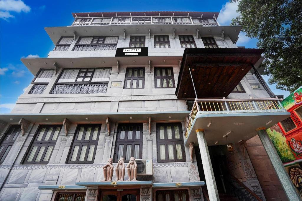 three people standing in front of a building at Palette by CheckIn Heritage Scindia Ghat in Varanasi