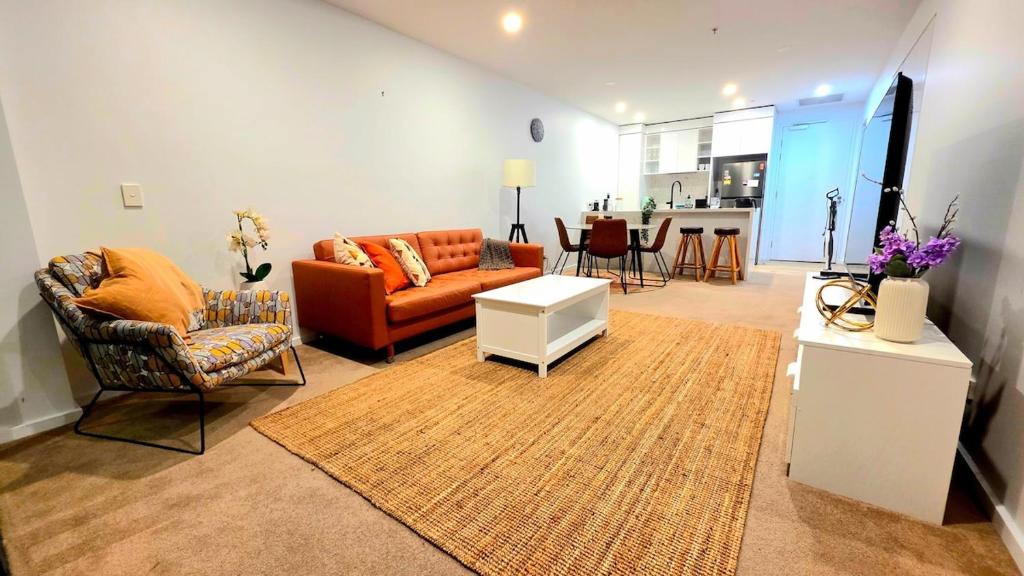 a living room with a couch and a table at Bliss in City in Canberra