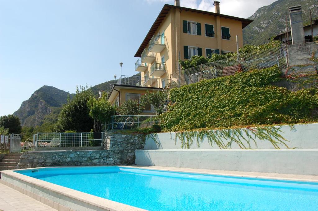 a swimming pool in front of a house at Hotel Panorama in Riva del Garda