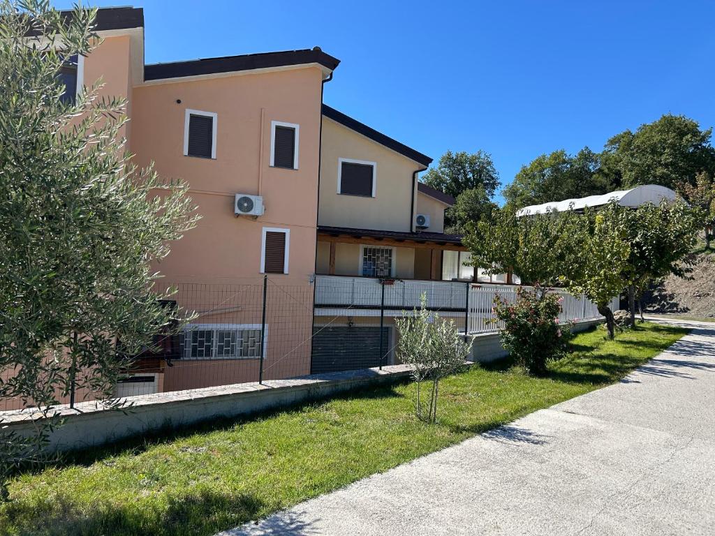 a house with a fence in front of a yard at SIRIS b&b - affittacamere in Chiaromonte