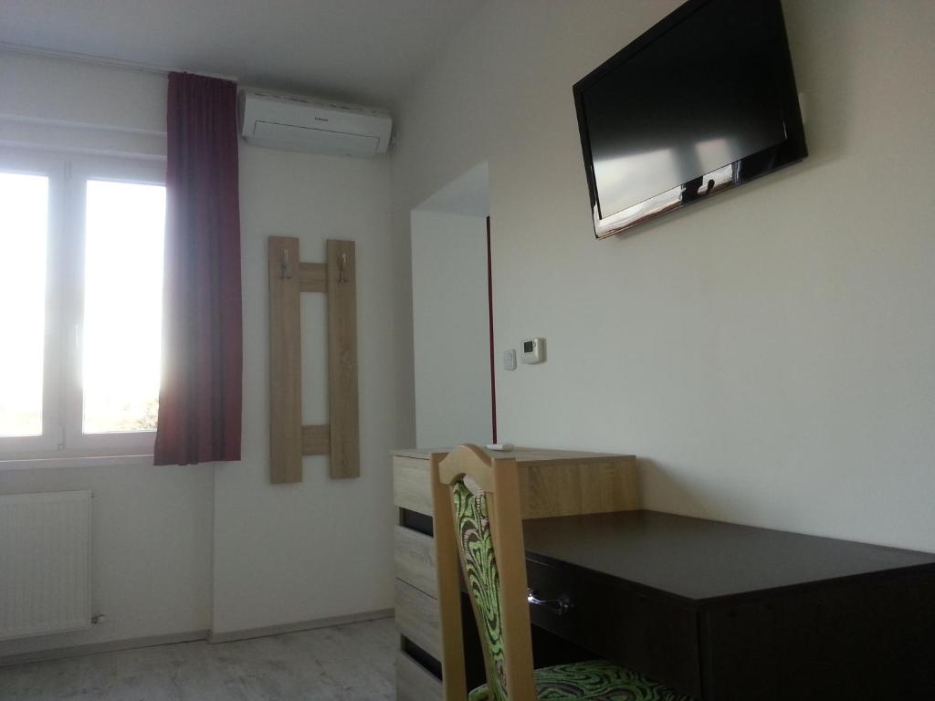 A television and/or entertainment centre at Downtown Apartment Miskolc